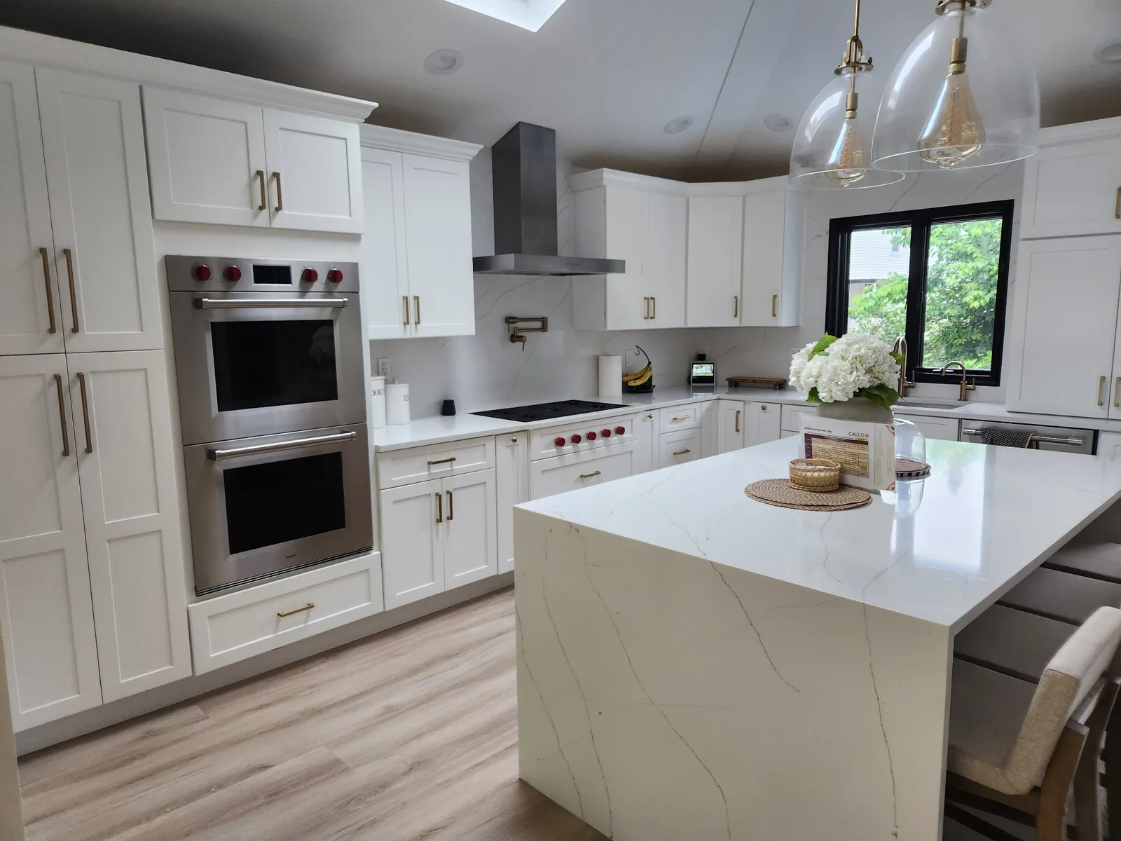 Two-tone kitchen remodel with quartz countertops by Augustine Construction